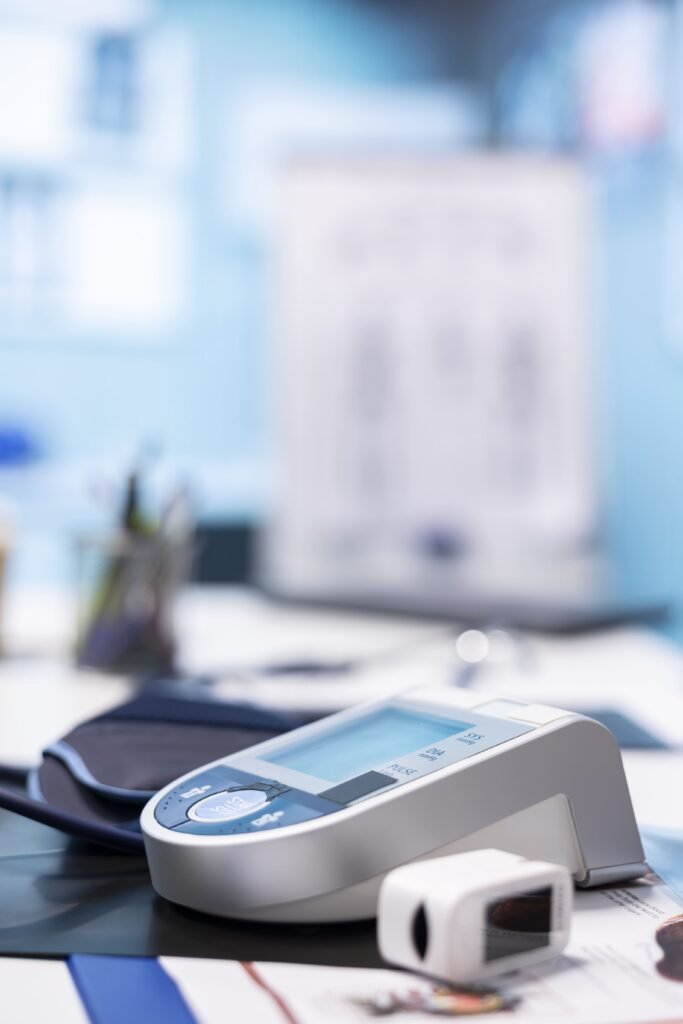 A medical device is on a table. There are also medical documents.